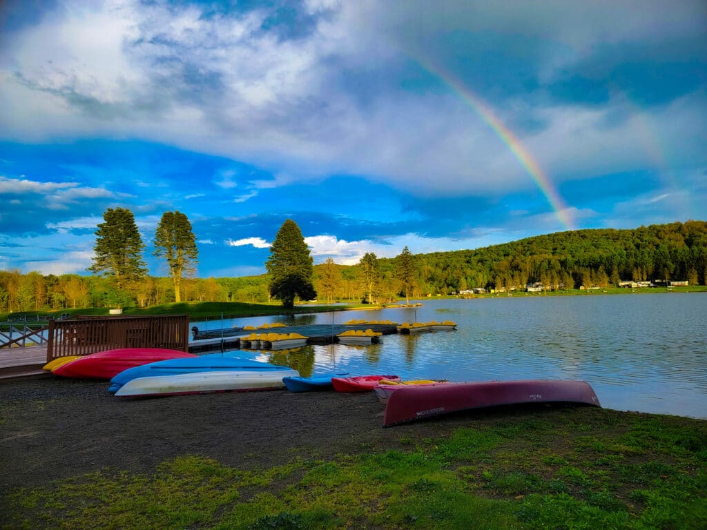 Canoes on the shore of Rainbow Lake at a western New York campground.