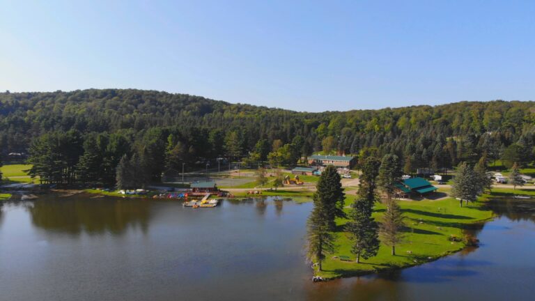 An aerial view of Rainbow Lake surrounded by trees in western New York.