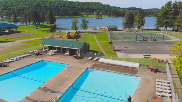 An aerial view of a family campground with swimming pool and tennis courts.