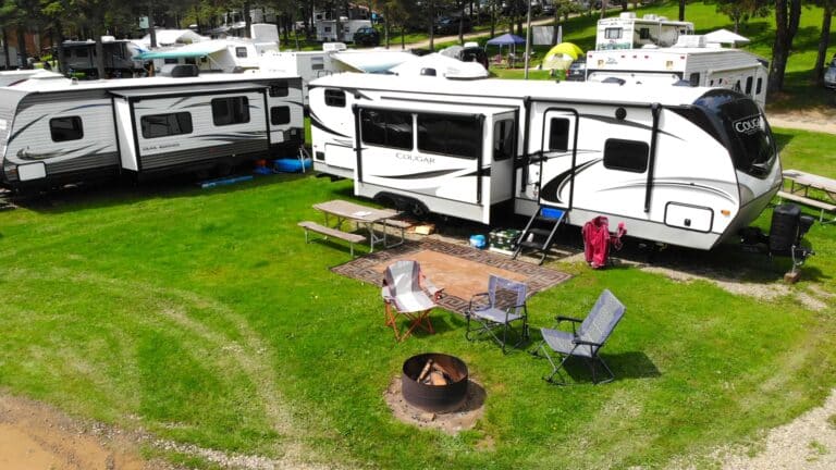 A group of RVs parked in a grassy campground area in WNY.