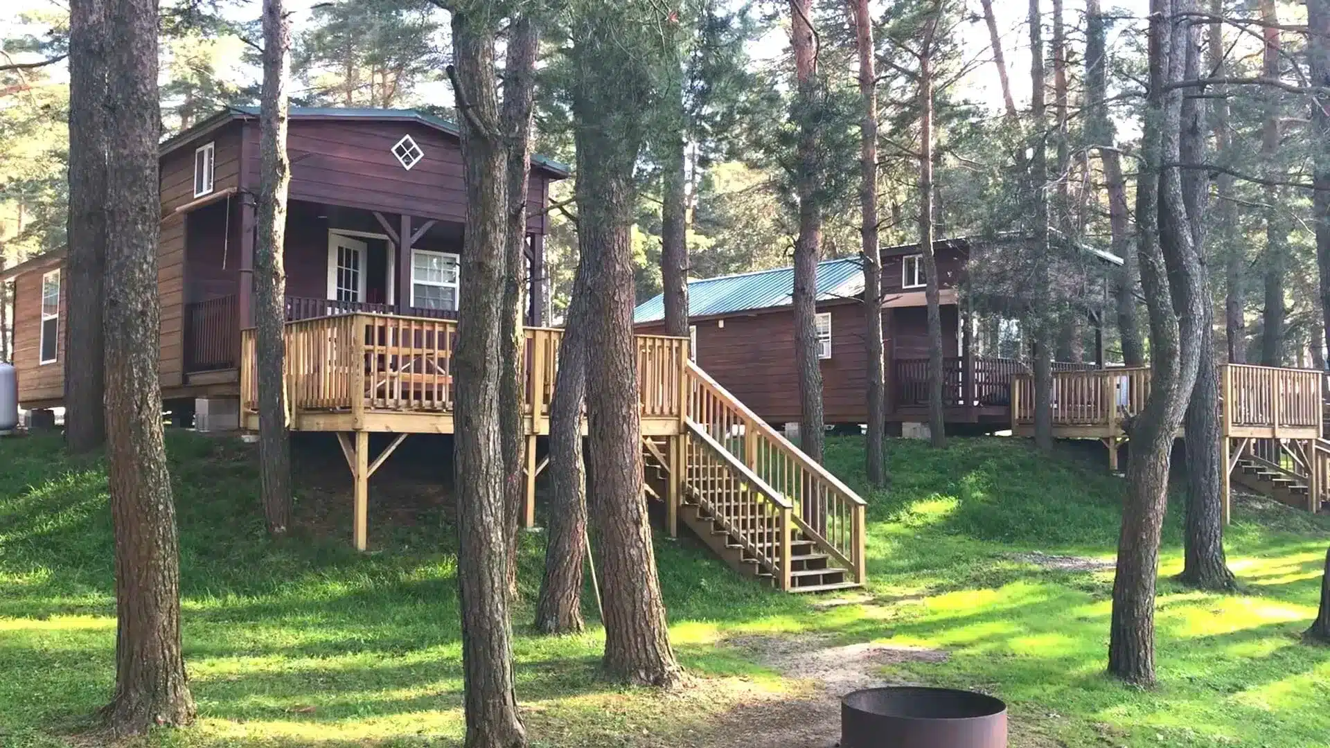 Cabins on raised decks among the pines at Allegany Mountain Resort