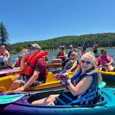 A group of people in kayaks on Rainbow Lake in Western New York.