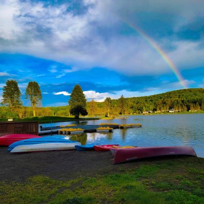 Canoes on the shore of Rainbow Lake at a western New York campground.