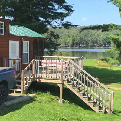 A blue truck is parked in front of a Campground.
