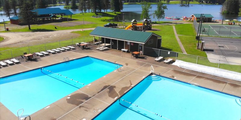 An aerial view of a swimming pool near Rainbow Lake at a campground.