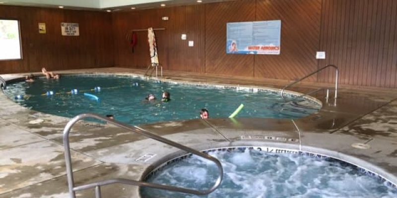 A group of people playing in a hot tub inside a cabin at an RV campground in WNY.