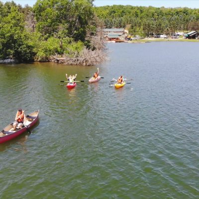 A group of people camping on a lake.