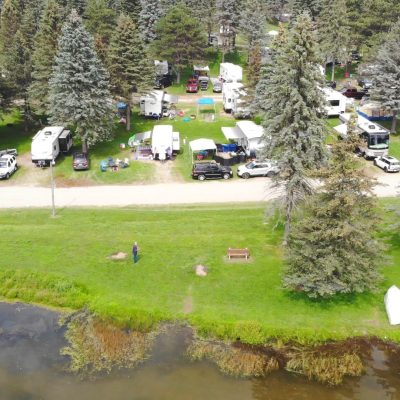 An aerial view of a family campground near a lake.
