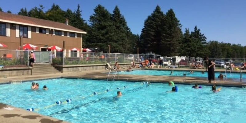 A large swimming pool in western New York with people playing in it.